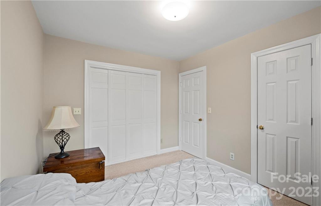 13514 O O'Malley Drive Matthews, NC 28105 - Photo 16 of 20 a bedroom with a bed and a lamp