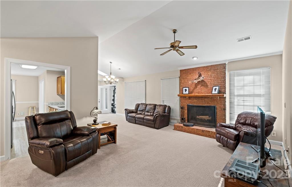 13514 O O'Malley Drive Matthews, NC 28105 - Photo 4 of 20 a living room with furniture a fireplace and a flat screen tv