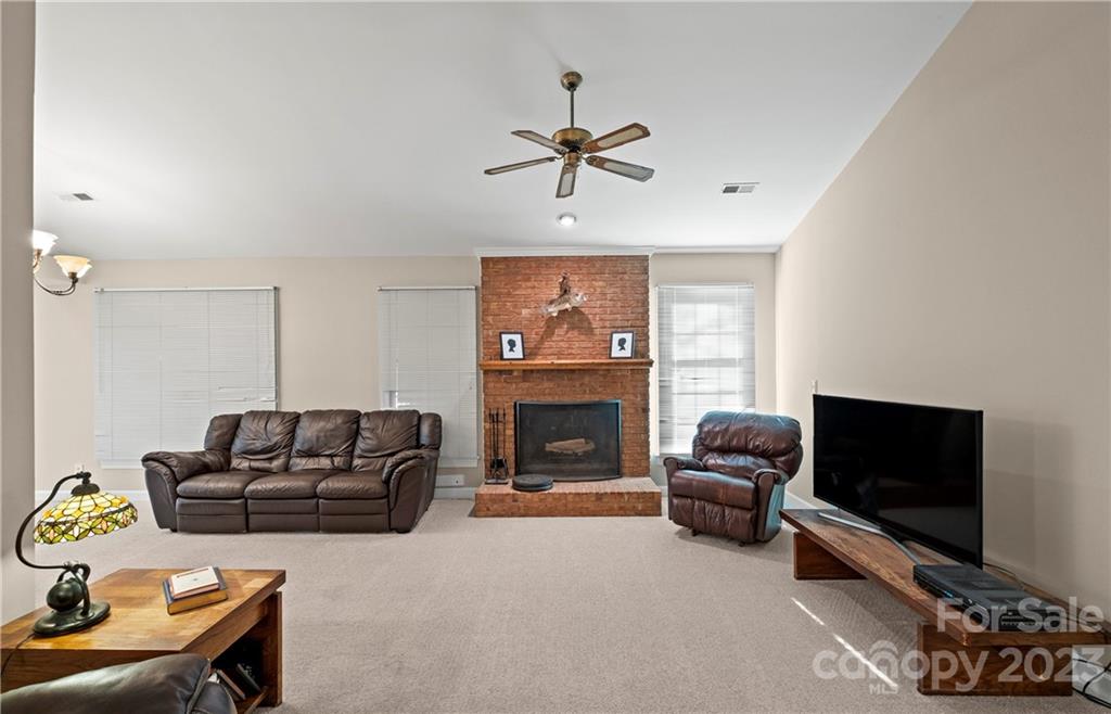 13514 O O'Malley Drive Matthews, NC 28105 - Photo 5 of 20 a living room with furniture a fireplace and a flat screen tv