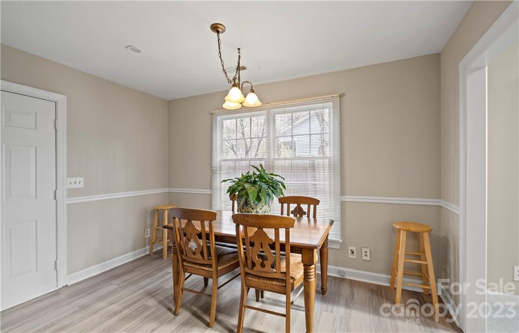 13514 O O'Malley Drive Matthews, NC 28105 - Photo 7 of 20 a view of a dining room with furniture window and wooden floor