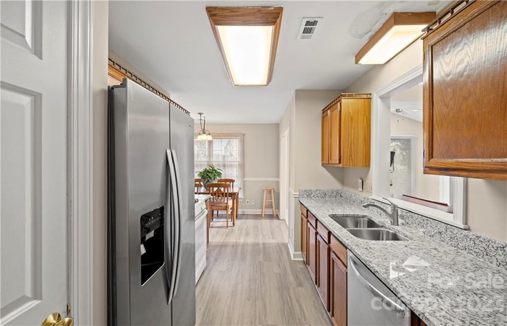13514 O O'Malley Drive Matthews, NC 28105 - Photo 8 of 20 a kitchen with stainless steel appliances granite countertop a sink a stove and a refrigerator