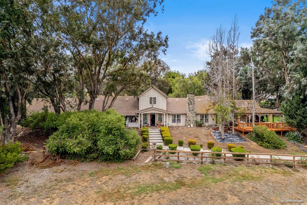 an aerial view of a house with swimming pool garden and patio