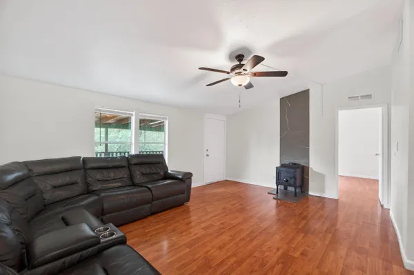 a view of a kitchen with a sink and wooden floor