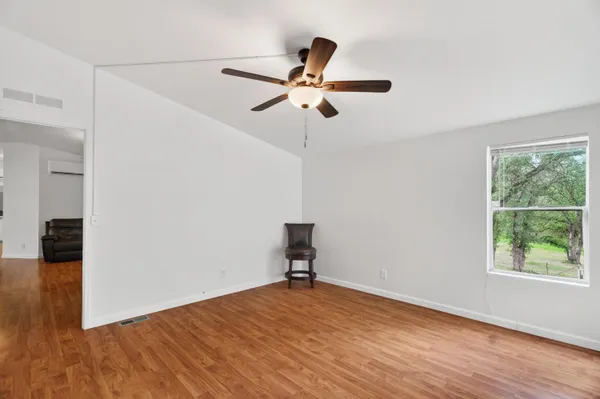 a view of a room with wooden floor and windows