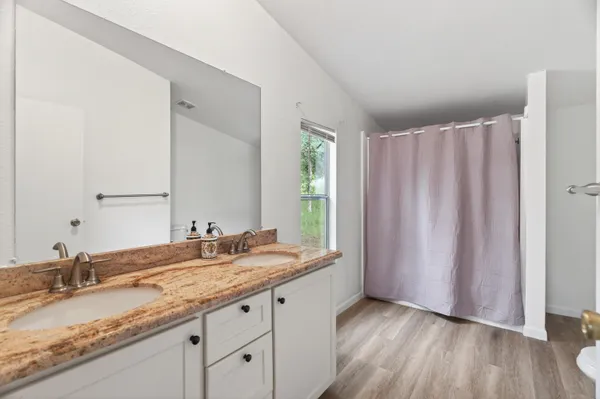 a view of walk in closet with wooden floor