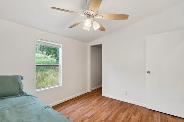 a view of room with window and ceiling fan