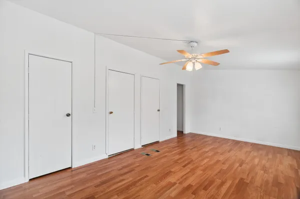 a backyard of a house with chairs and wooden fence