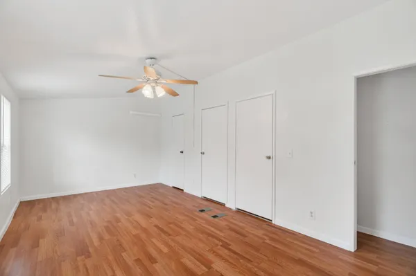 a backyard of a house with lots of green space and lake view