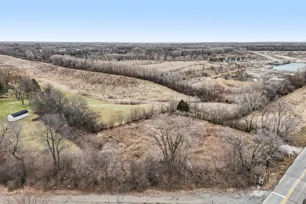 a view of a field with trees in the background