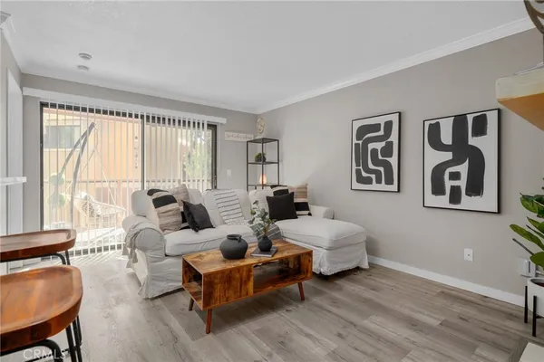 a living room with couches a coffee table and next to a window