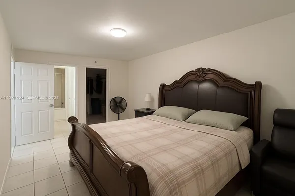 a bedroom with a bed and a dresser