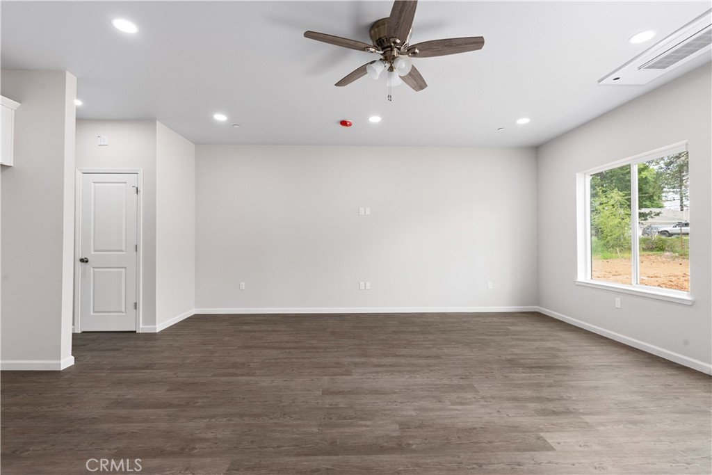 5583 Linrich Lane Paradise, CA 95969 - Photo 11 of 33 a view of an empty room with wooden floor and a window