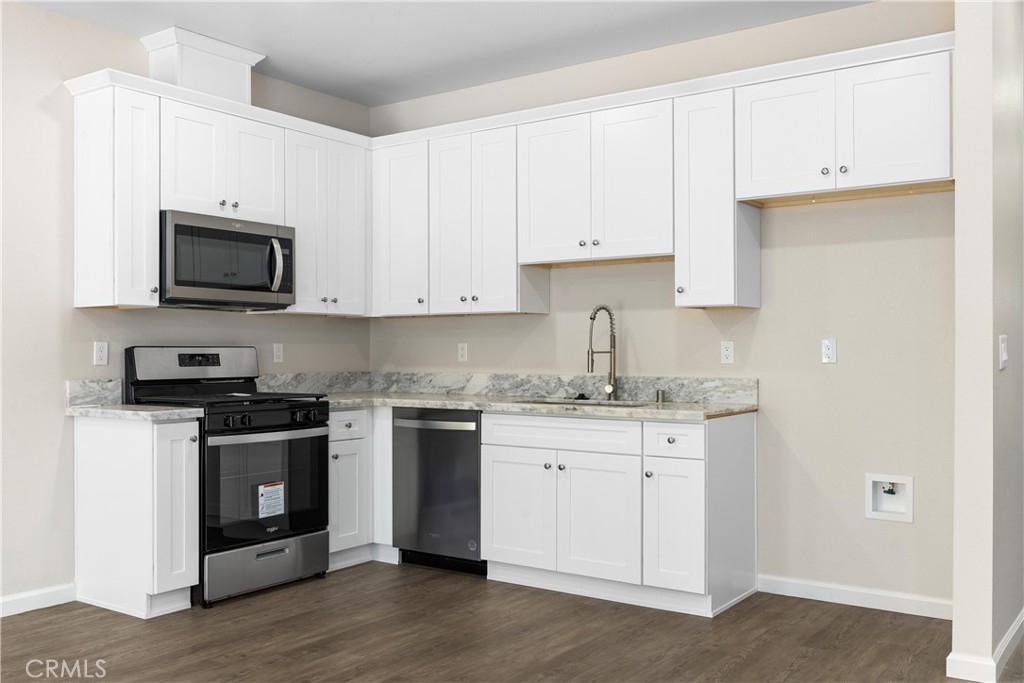 5583 Linrich Lane Paradise, CA 95969 - Photo 13 of 33 a kitchen with granite countertop white cabinets and stainless steel appliances