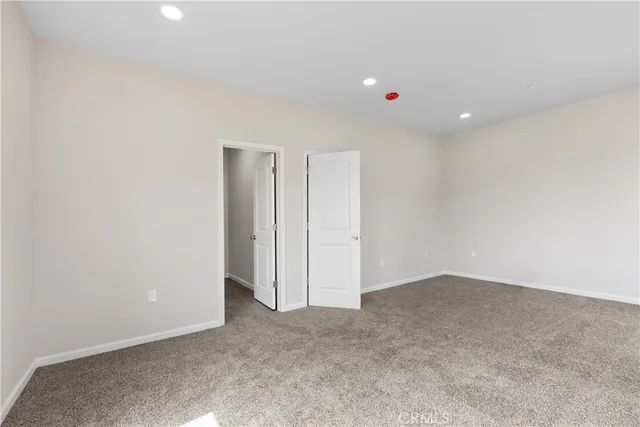 a view of a hallway with closet and wooden floor