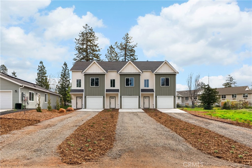 5583 Linrich Lane Paradise, CA 95969 - Photo 3 of 33 a view of a white house next to a yard with large trees