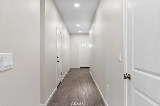 a view of a hallway with wooden floor