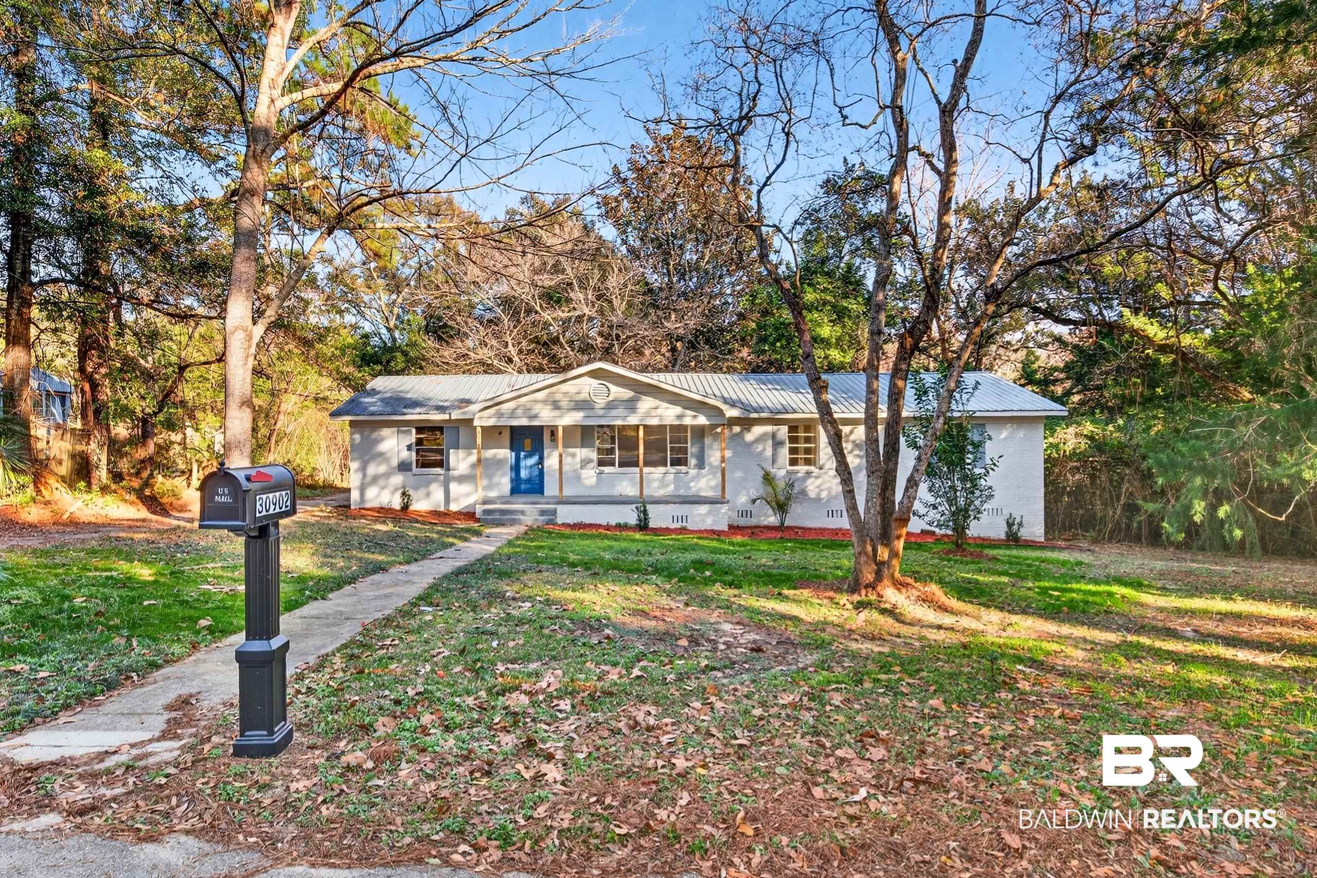 30902 Stanton Road Spanish Fort, AL 36527 - Photo 25 of 27 Single story home with a metal roof, a front lawn, and a porch