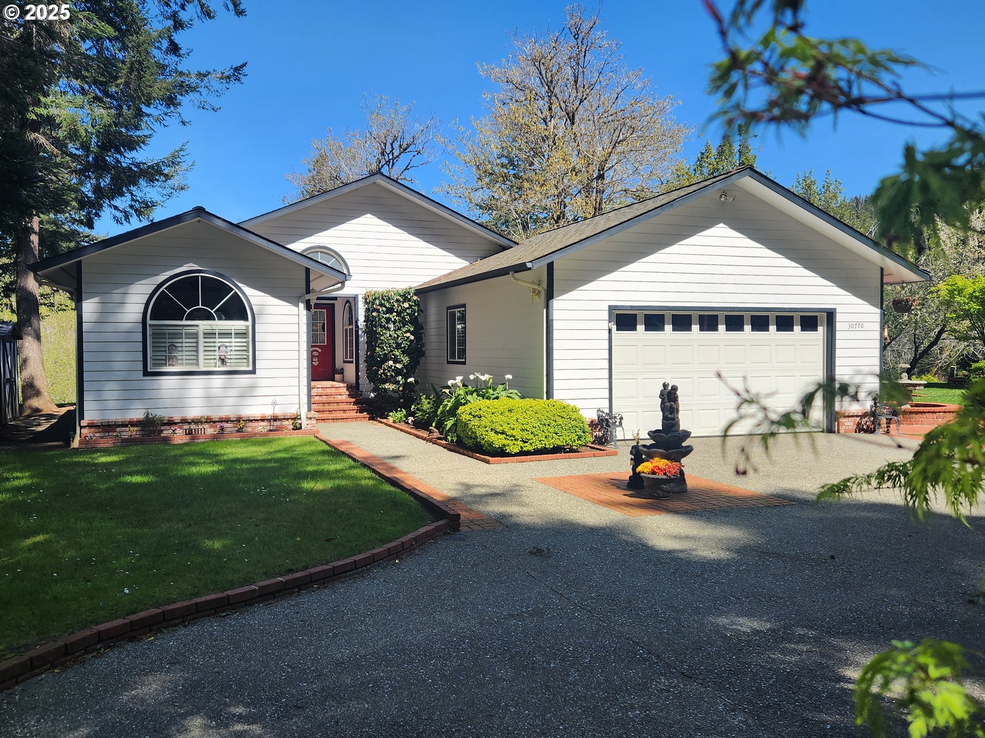 a view of a house with outdoor space and garden