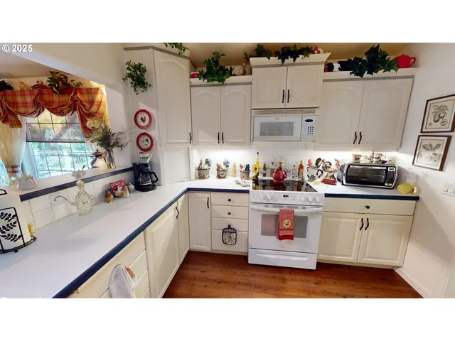 a kitchen with kitchen island sink stove and cabinets