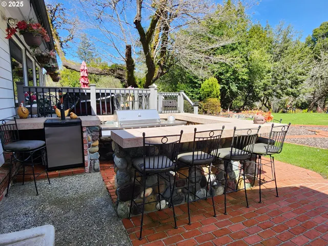 a view of an outside dining space with a table and chairs