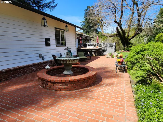 a view of a house with backyard and sitting area