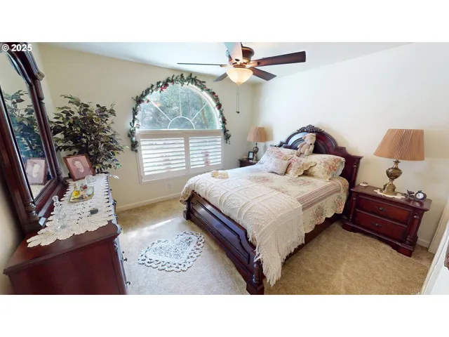 a living room with a bed furniture and a window