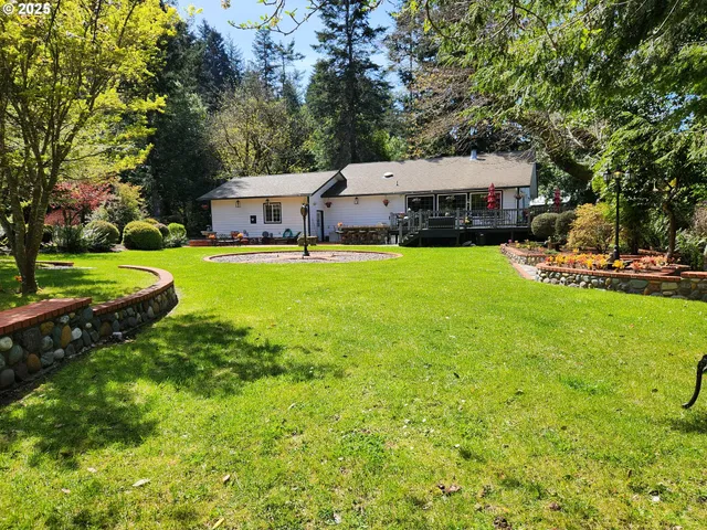 a aerial view of a house with swimming pool garden and trees