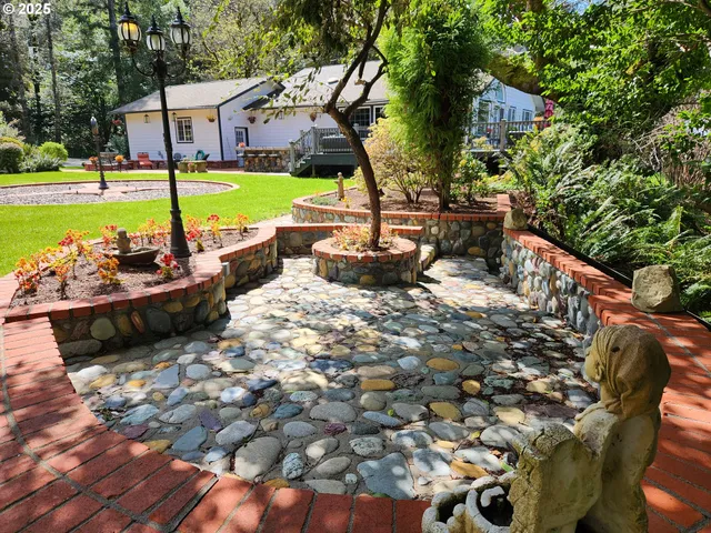 a view of a house with backyard sitting area and garden