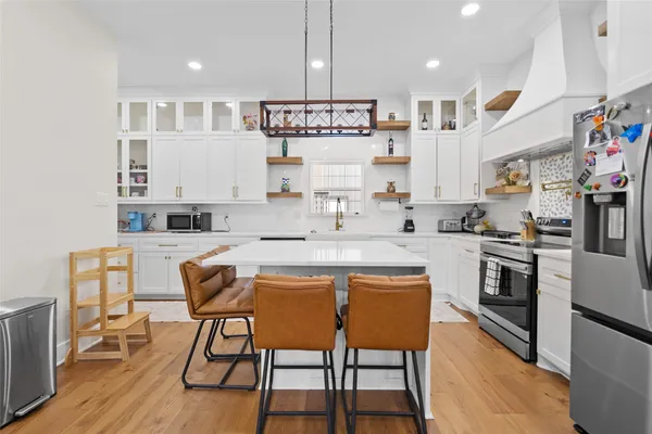 a kitchen with stainless steel appliances granite countertop a sink and a stove