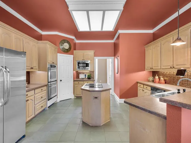 a kitchen with refrigerator and cabinets