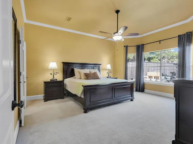 a spacious bedroom with a bed and a chandelier