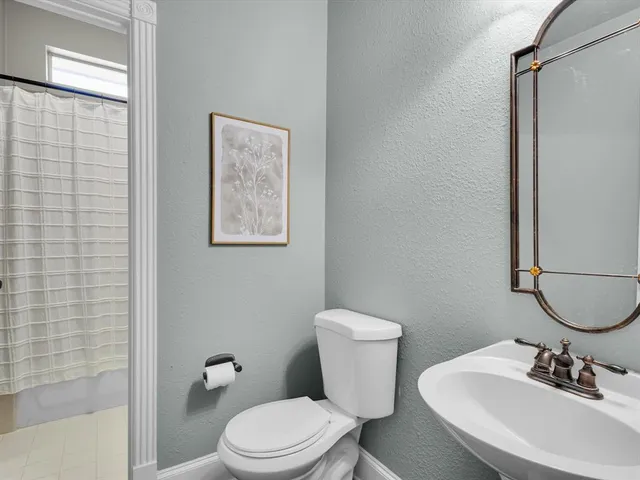 a white toilet sitting next to a bathroom sink