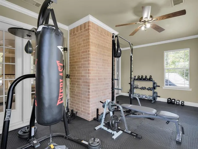 a room with gym equipment and windows