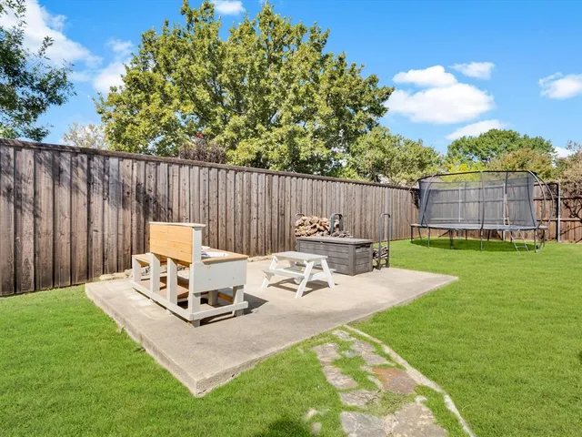a view of a backyard with chair and a garden