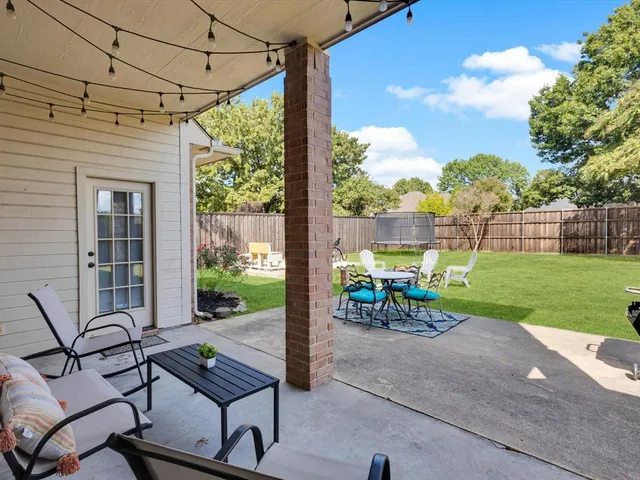a view of a porch with furniture and garden