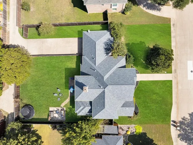 an aerial view of a house with a yard
