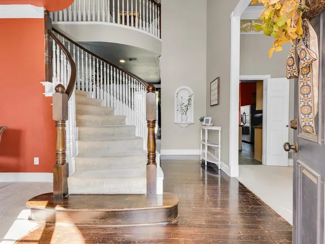 a view of entryway livingroom and hall with wooden floor