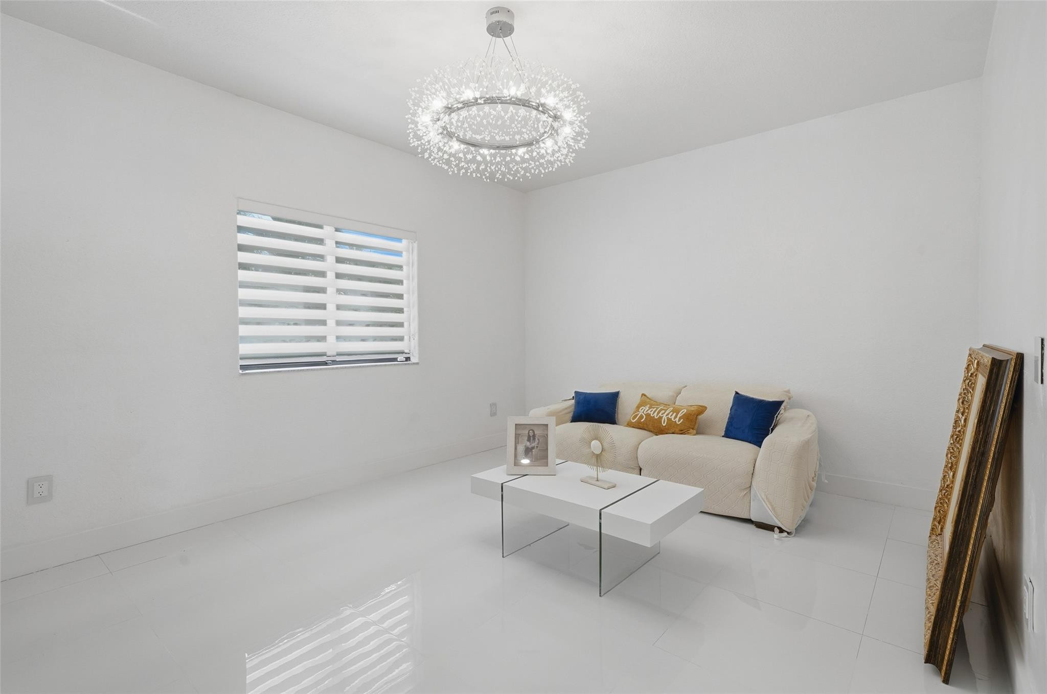 4429 Southwest 165th Court Miami, FL 33185 - Photo 11 of 58 a living room with furniture and a chandelier