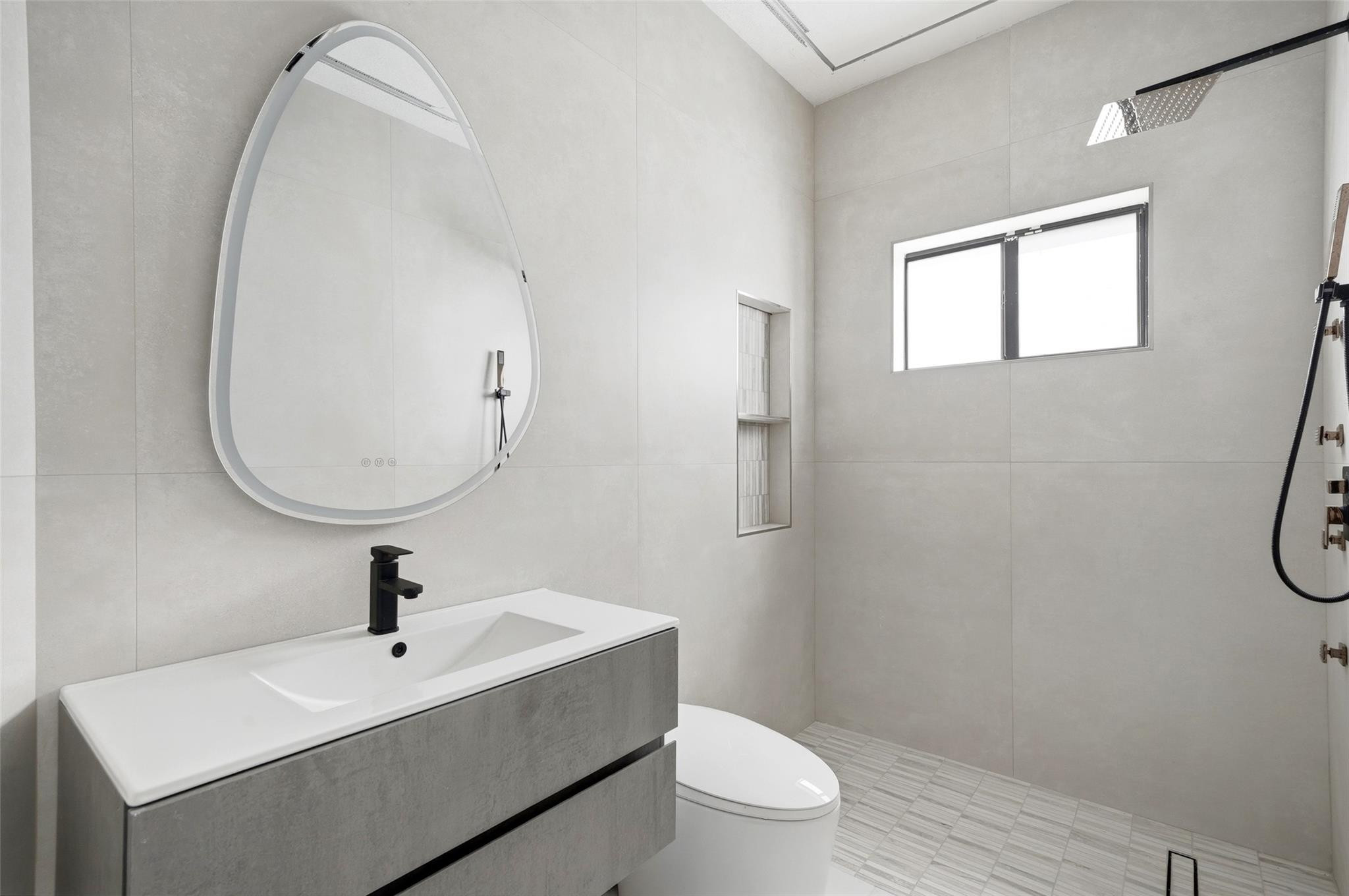 4429 Southwest 165th Court Miami, FL 33185 - Photo 14 of 58 a bathroom with a toilet a sink a mirror and vanity