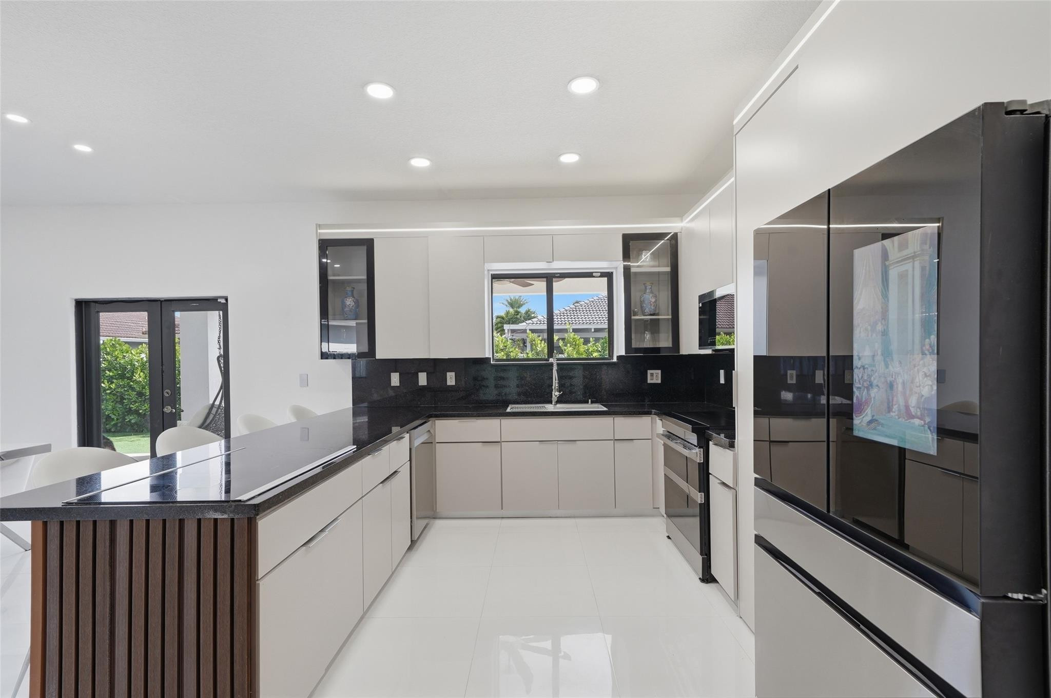 4429 Southwest 165th Court Miami, FL 33185 - Photo 16 of 58 a large white kitchen with a large window