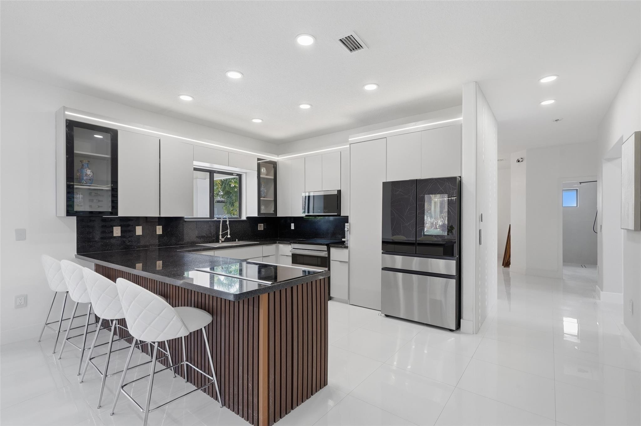 4429 Southwest 165th Court Miami, FL 33185 - Photo 17 of 58 a kitchen with stainless steel appliances granite countertop a stove top oven a sink and a refrigerator