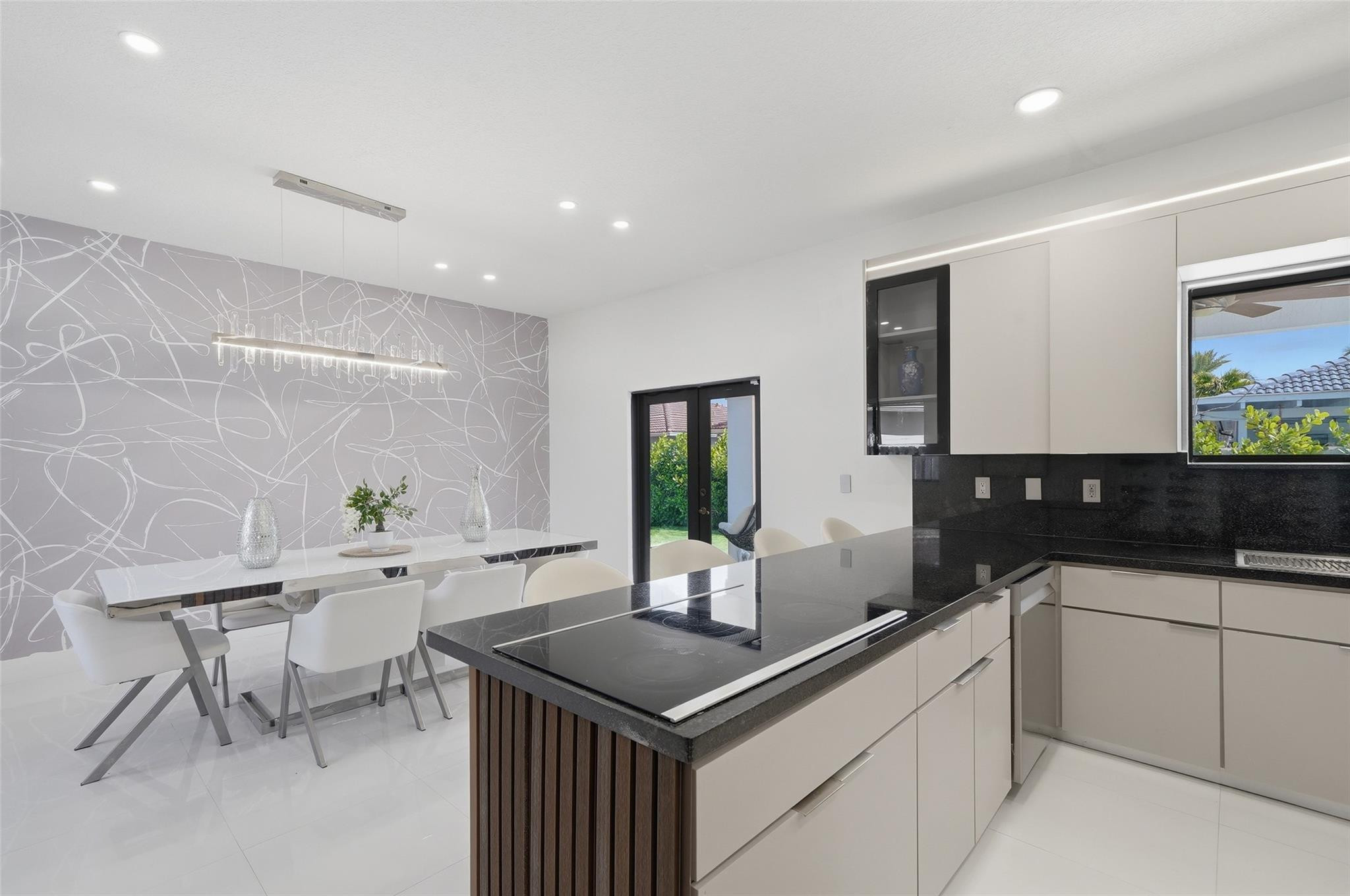 4429 Southwest 165th Court Miami, FL 33185 - Photo 21 of 58 a kitchen with granite countertop a sink and white cabinets