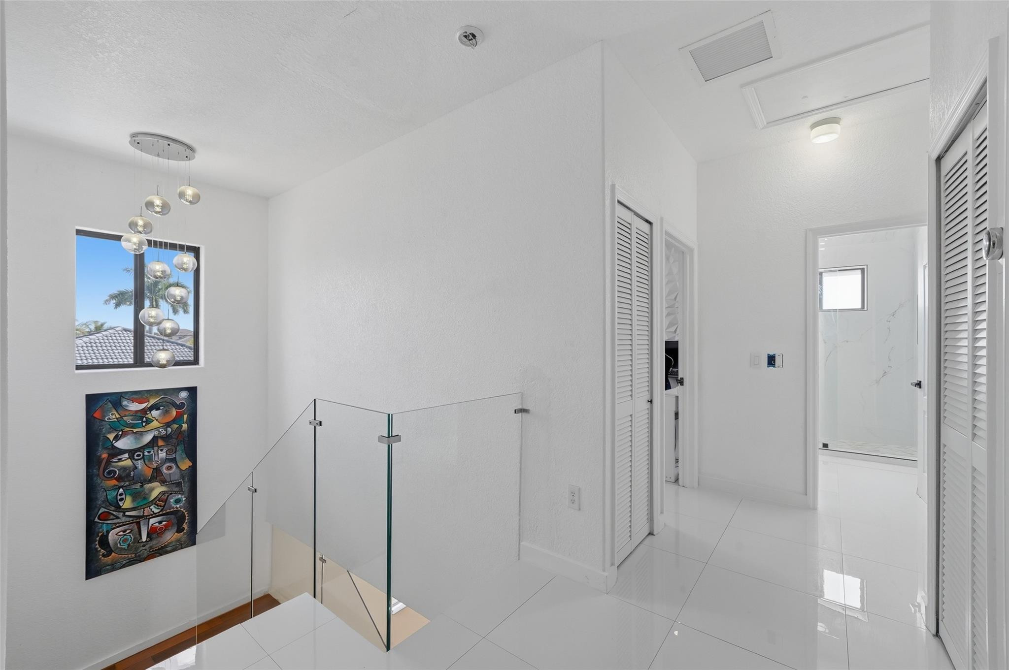 4429 Southwest 165th Court Miami, FL 33185 - Photo 28 of 58 a view of a hallway with paintings on the wall