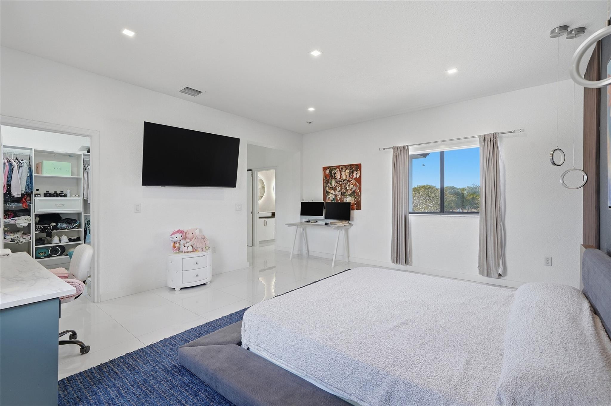 4429 Southwest 165th Court Miami, FL 33185 - Photo 41 of 58 a bedroom with a bed and a flat screen tv