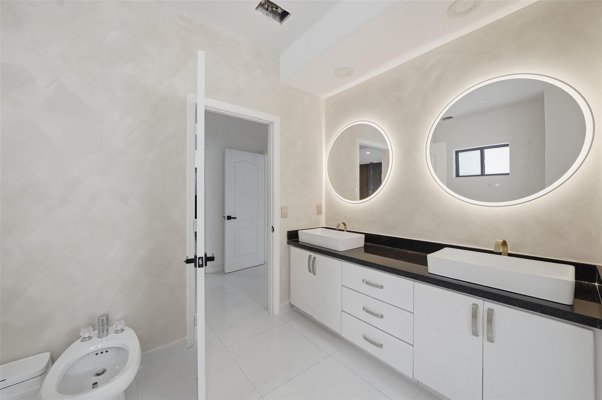 4429 Southwest 165th Court Miami, FL 33185 - Photo 48 of 58 a bathroom with a double vanity sink and a mirror