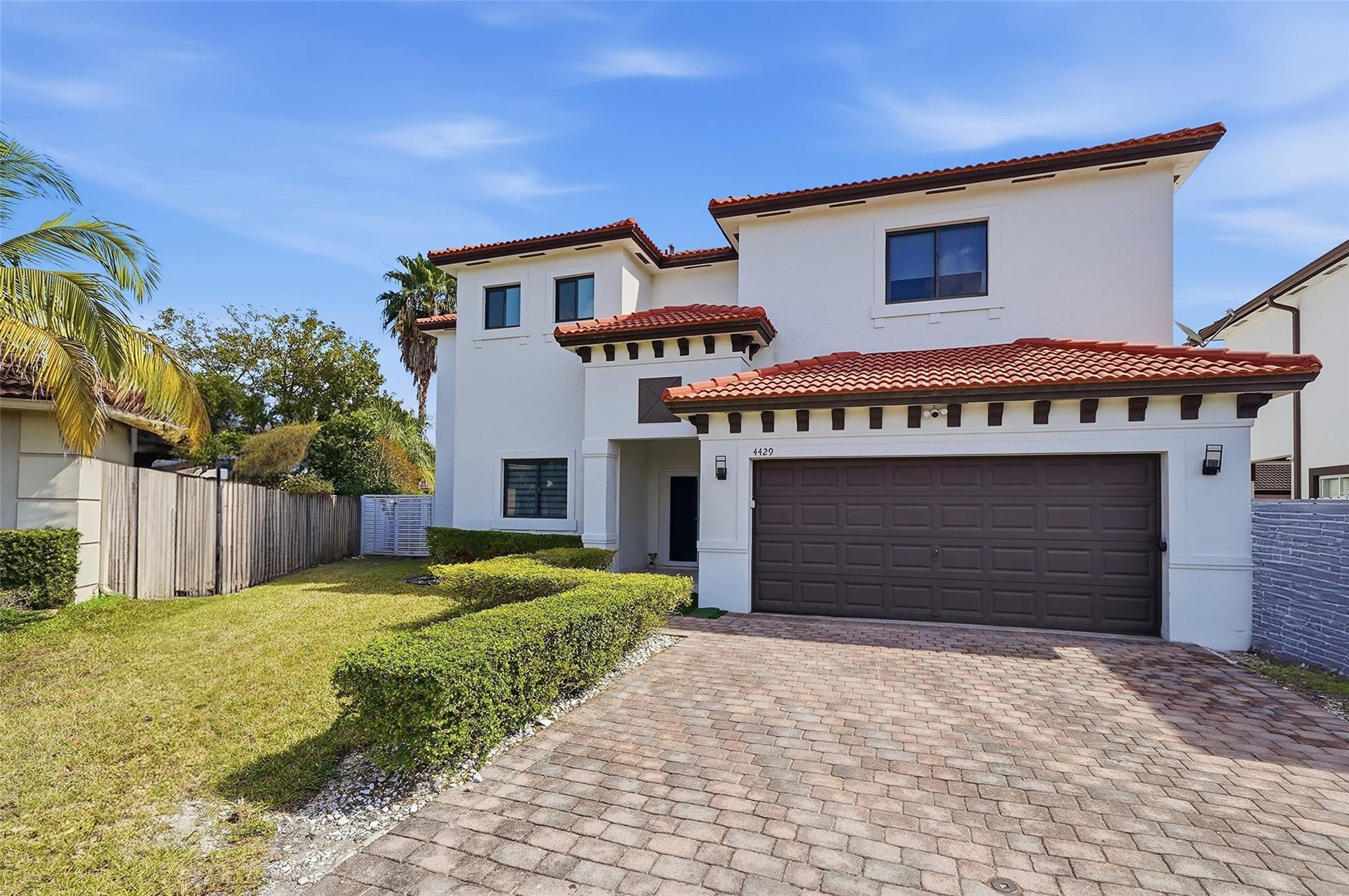 4429 Southwest 165th Court Miami, FL 33185 - Photo 5 of 58 a front view of a house with a yard and garage