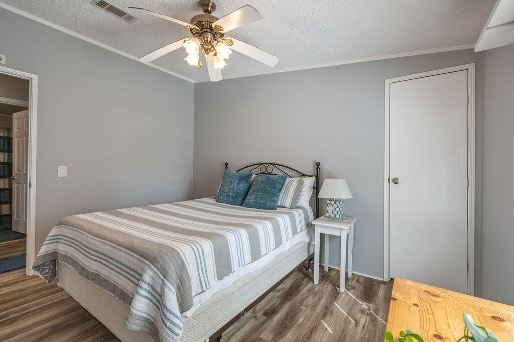 191 Beech Street Freeport, FL 32439 - Photo 11 of 18 a bedroom with a bed and a chandelier