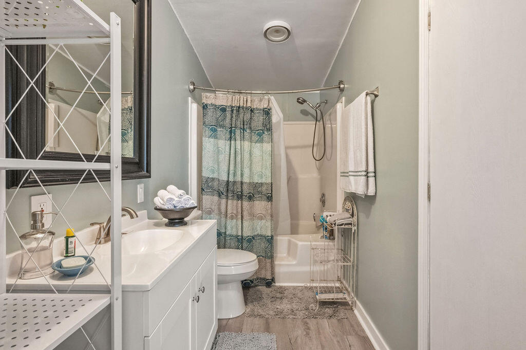 191 Beech Street Freeport, FL 32439 - Photo 13 of 18 a bathroom with a granite countertop sink a toilet and shower