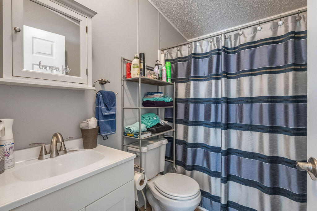 191 Beech Street Freeport, FL 32439 - Photo 14 of 18 a bathroom with a toilet a sink and a window