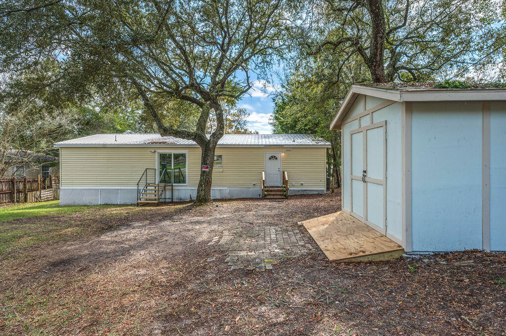 191 Beech Street Freeport, FL 32439 - Photo 16 of 18 a view of a house with a yard and large tree